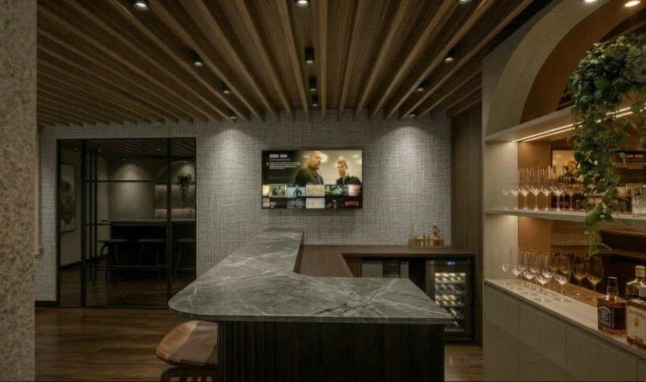 Bar da sala VIP com bancada de pedra e TV